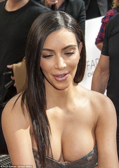 Kim Kardashian Displays Plenty Of Cleavage In A Semi Sheer Bandeau Wrap Dress exclusive gallery photo - high quality adult content